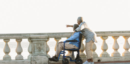 A caregiver and a man in a wheelchair