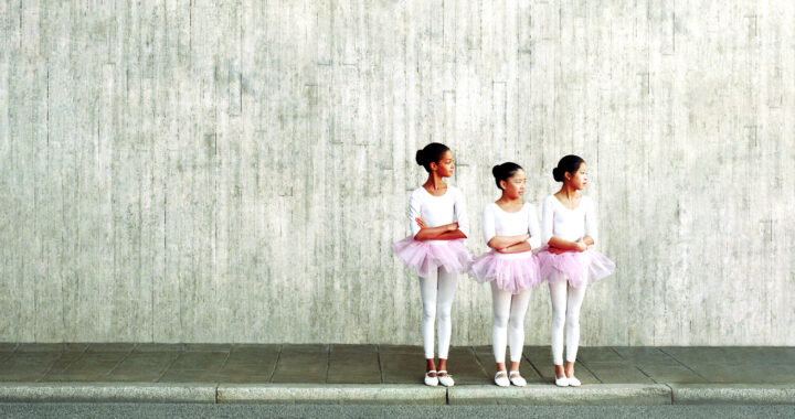 Three young ballerinas in a line.