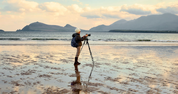 A woman on a beach taking photos