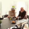 a man and woman sit together at a table talking