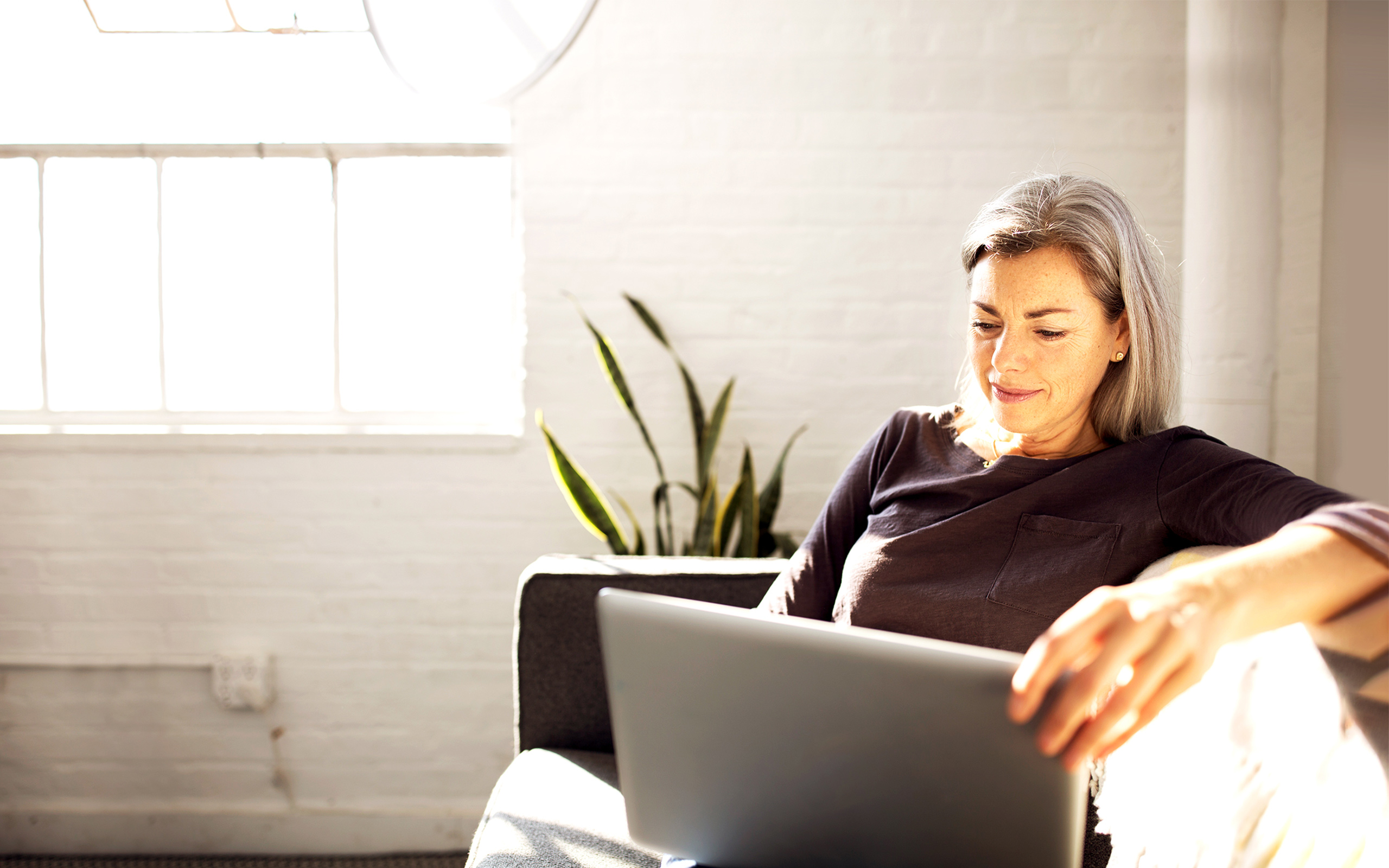 Woman reviews data on her computer