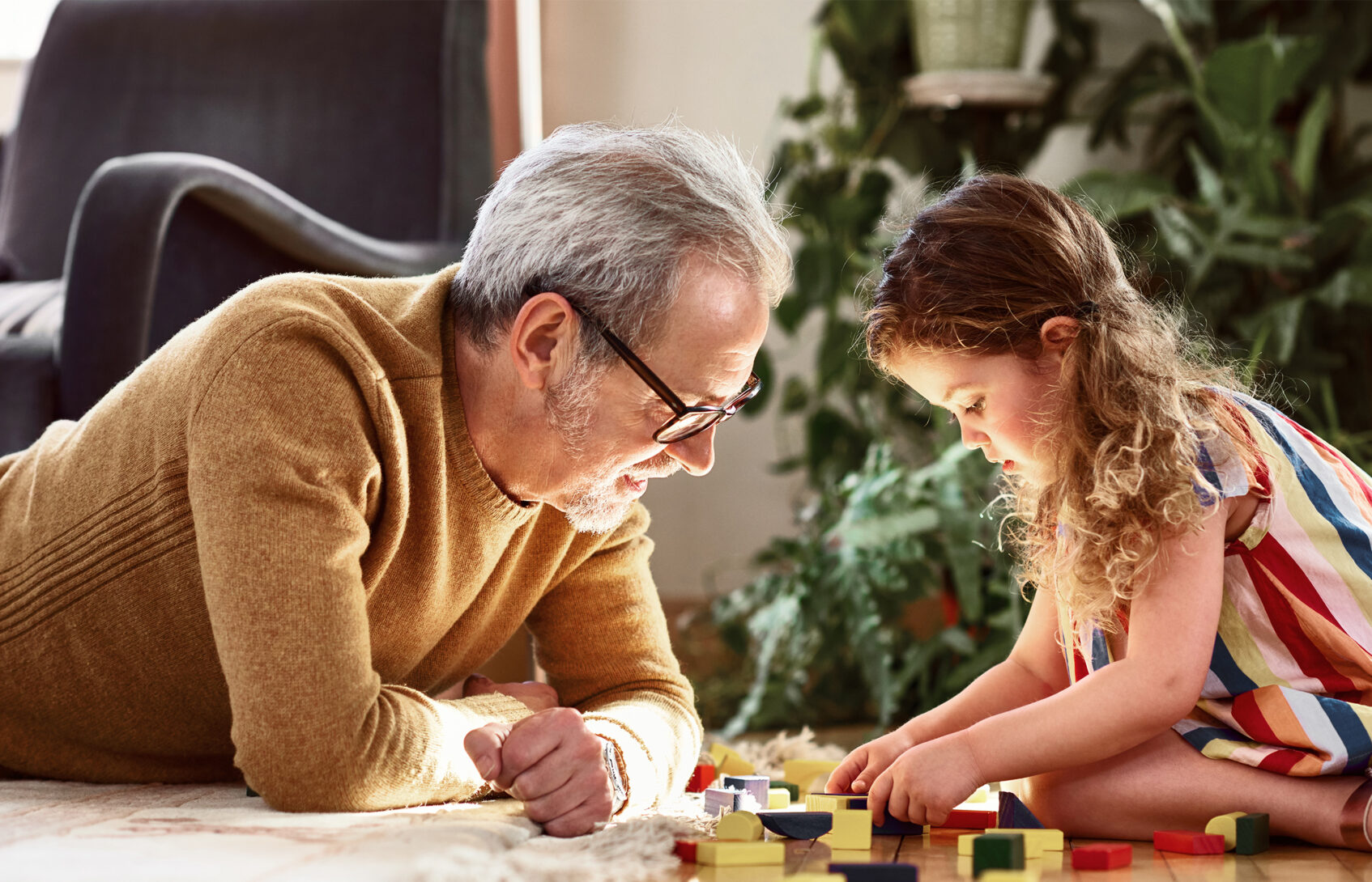 A man and a young girl work on a puzzle together