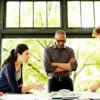 A business owner talks with key advisors