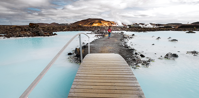 A wooden pathway leads to the blue lagoon geothermal spa in Iceland.
