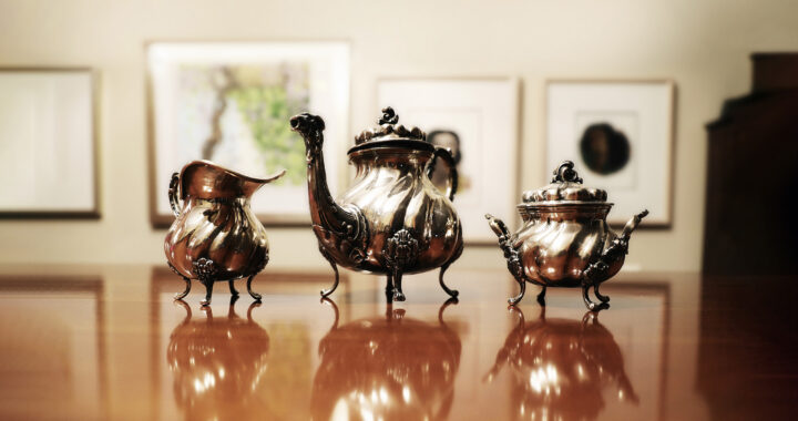 A silver tea set displayed on a table