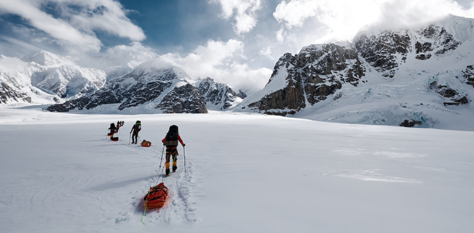 Mountaineers climbing at Denali National Park pulling a sled.