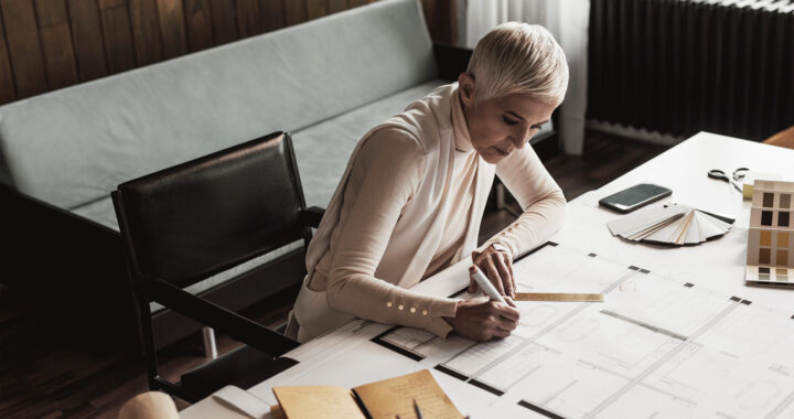 Businesswoman drawing plans from home studio.