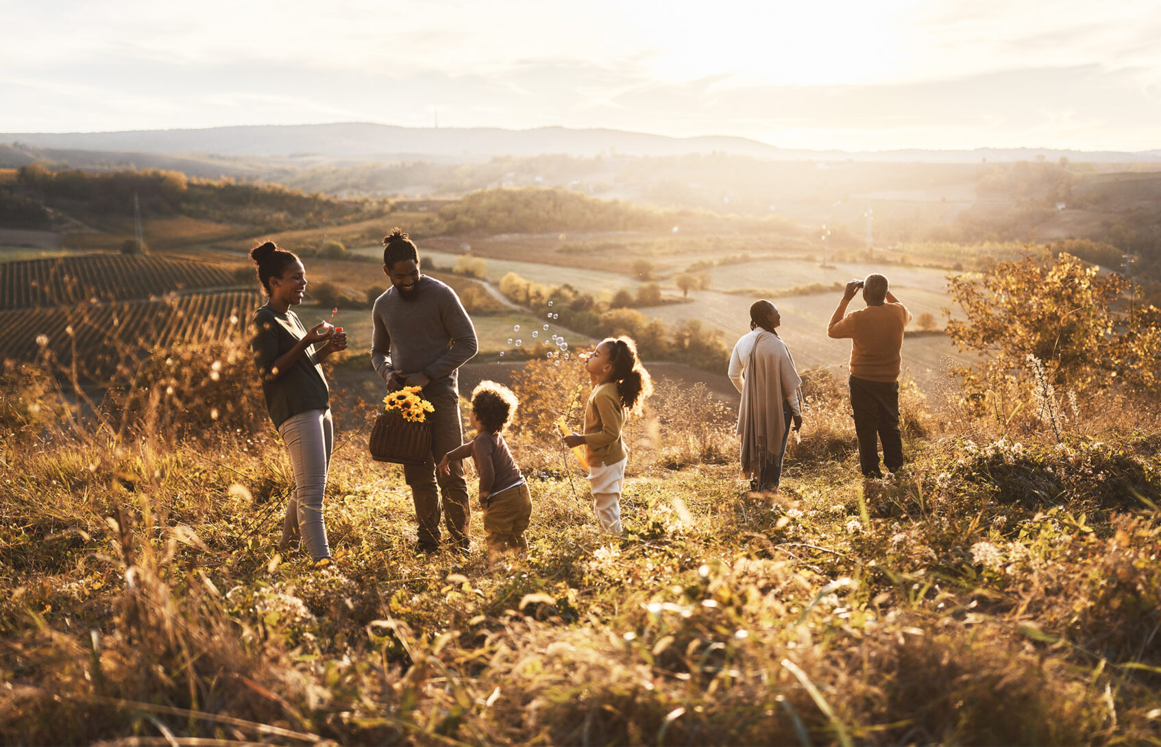 Family gathering flowers on a hillside.