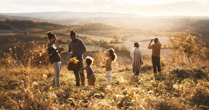 Family gathering flowers on a hillside.