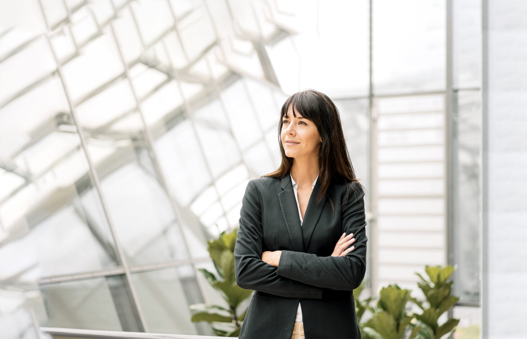 Businesswoman with arms crossed smiling.