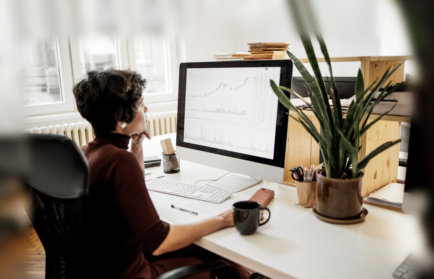 Young woman examining the changes in the stock market at her office.