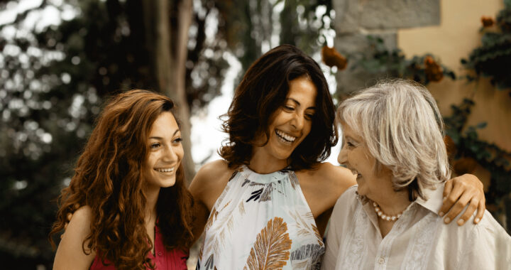 Three generations of female family together smiling.