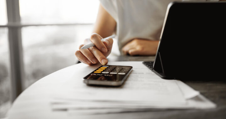 A woman reviewing finances at home.