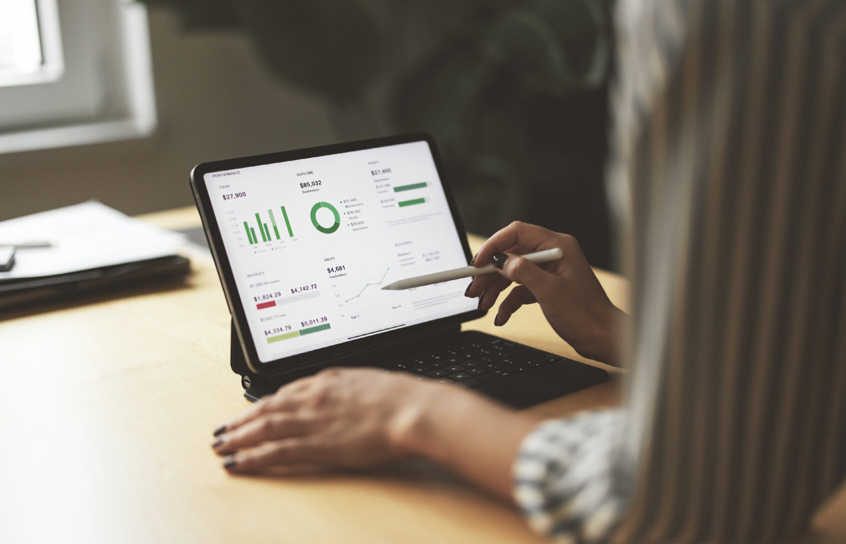 A woman uses her digital tablet to check the state of her finances