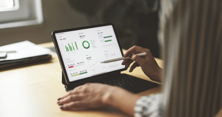 A woman uses her digital tablet to check the state of her finances