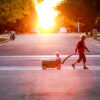 A grandparent pulls a young child in a wagon across the street Read about What do I need to know about Social Security survivor benefits?